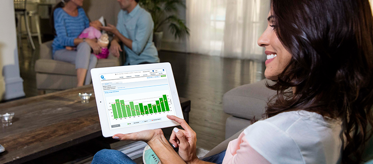 Woman looking at energy dashboard on tablet device