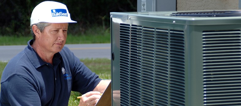 Man inspecting air conditioner