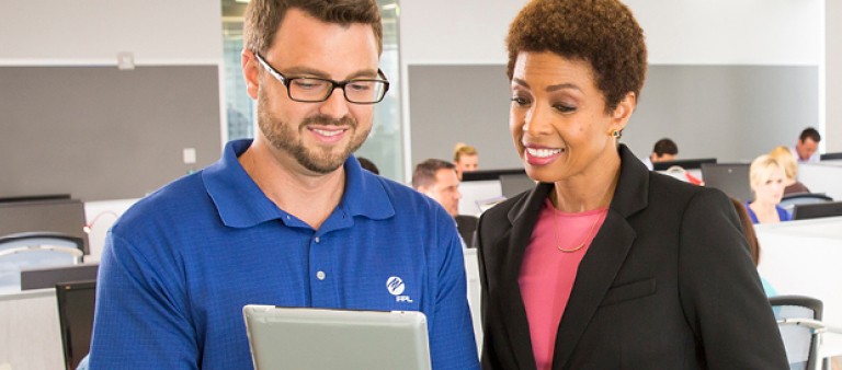 Woman and man looking at tablet device