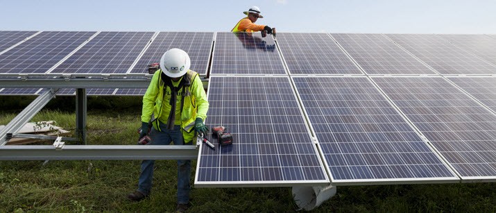 Two men doing construction on solar panels