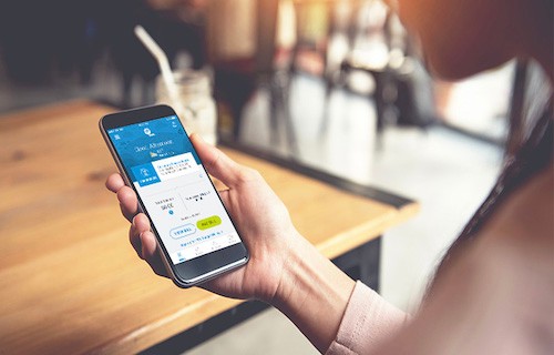 woman checking mobile app at cafe