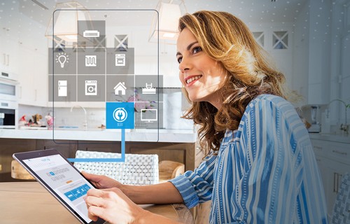 Woman looking at energy analyzer on a tablet device