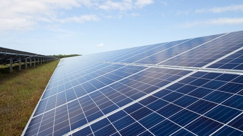 Side view of a solar panel field