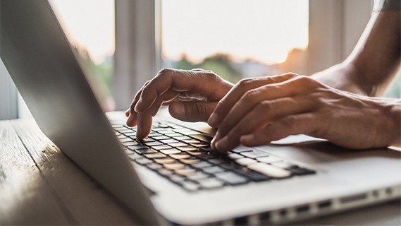 Hands typing on computer keyboard 