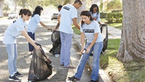 people cleaning up street during storm recovery